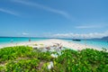 Pile of single use plastic bottles and other on otherwise pristine tropical island