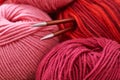 Pile skeins of yarn and knitting needles