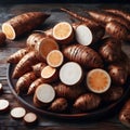 A pile of sliced and whole taro roots with a detailed view of their fibrous texture and intricate patterns, showcasing their