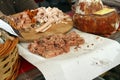 Pile of slices dried salami on cutting board. Different kinds of dry salami and sausages. Slices of jerky meat. Gourmet bites of s