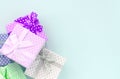 Pile of a small colored gift boxes with ribbons lies on a violet background. Minimalism flat lay top view Royalty Free Stock Photo