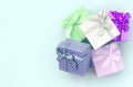 Pile of a small colored gift boxes with ribbons lies on a violet background. Minimalism flat lay top view Royalty Free Stock Photo