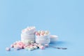 Pile of small colorfull marshmallow on blue background in bowl Royalty Free Stock Photo