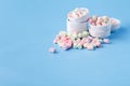 Pile of small colorfull marshmallow on blue background in bowl Royalty Free Stock Photo