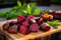 a pile of small oven-roasted beets on a wooden chopping board