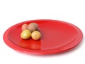 A pile of small potatoes on a red plate