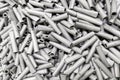 A pile of small steel sand blasted tubes - close-up with selective focus and blur