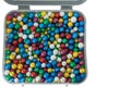 pile of small thermocol colorful balls in a plastic box isolated on a white background Royalty Free Stock Photo