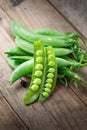 Pile of snow peas on wood background. Royalty Free Stock Photo