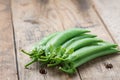 Pile of snow peas on wood background. Selective focus. Royalty Free Stock Photo