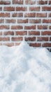 Winter snow pile in front of brick wall Royalty Free Stock Photo