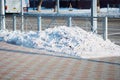 A pile of snow on the street in winter after cleaning the sidewalk. Royalty Free Stock Photo