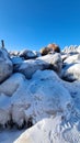 Pile of snowy rocks in the winter mountains on a sunny winter day with a blue sky