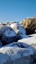 Pile of snowy rocks in the winter mountains on a sunny winter day with a blue sky