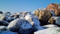 Pile of snowy rocks in the winter mountains on a sunny winter day with a blue sky