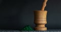 Pile of spirulina powder and wooden pounder on stone surface table on black background. Copy space, natural ingredient supplements