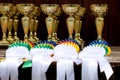 Pile of sport trophies and badges rosettes for the winners on show jumping competition