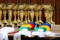 Pile of sport trophies and badges rosettes for the winners on show jumping competition