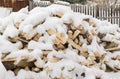 Pile, stack of birch wood under the snow in the winter Royalty Free Stock Photo