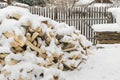 Pile, stack of birch wood under the snow in the winter Royalty Free Stock Photo