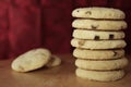 Pile or stack of choc chip and fruit cookies, on a wooden table Royalty Free Stock Photo