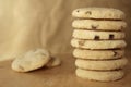 Pile or stack of choc chip and fruit cookies, on a wooden table Royalty Free Stock Photo