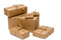 Pile of boxes wrapped with brown kraft paper and tied with twine on a white background. Delivery, moving, gifts concept Royalty Free Stock Photo