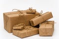 Pile of stacked boxes wrapped with brown kraft paper and tied with twine on a white background. Logistic concept Royalty Free Stock Photo