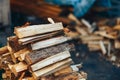 A pile of stacked firewood, prepared for heating the house. Gathering fire wood for winter or bonfire. Man holds fire wood in Royalty Free Stock Photo