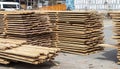 Pile of stacked wooden planks at a construction site. Wooden boards, lumber. Industrial edged timber. Wooden rafters for Royalty Free Stock Photo