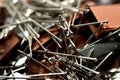 A pile of stapler staples and nickel plated steel pins, stack of paper pin background, a closeup of office pins Royalty Free Stock Photo