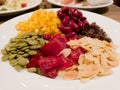 Pile of the steam yellow corn, red bean, sunflower seed, almond, raisin and sweet dried jujube, salad and healthy food