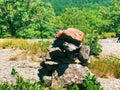 A pile of stones cairn marker on iron trail