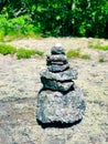 A pile of stones cairn marker on iron trail