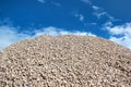 Pile of stones in lime rock quarry against blue sky background