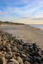 Pile of stones near a sandy beach on the sunset Royalty Free Stock Photo