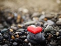 A pile of stones on the seashore, red heart at the top, zen relax Royalty Free Stock Photo