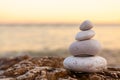 Pile of Stones on Tranquil Beach at Sunset Royalty Free Stock Photo