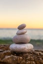 Pile of Stones on Tranquil Beach at Sunset Royalty Free Stock Photo