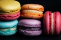 Pile of sweet colourful macaroons on black