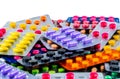 Pile of tablet pills on white background. Yellow, purple, black, orange, pink , green tablet pills in blister pack. Royalty Free Stock Photo