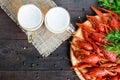 A pile of tasty boiled crawfish on a round wooden tray and two Royalty Free Stock Photo