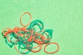 Pile thin rubber bands for hair on craft paper from above is close