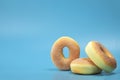Pile with three simple donuts with sugar isolated on blue background with copyspace, fast food,sugar concept Royalty Free Stock Photo