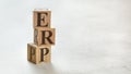 Pile with three wooden cubes - letters ERP meaning Enterprise Resources Planning on them, space for more text / images at right Royalty Free Stock Photo