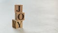 Pile with three wooden cubes - letters JOY on them, space for more text / images on right side Royalty Free Stock Photo