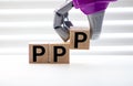 Pile with three wooden cubes - letters PPP meaning Praise Picture Push on them, space for more text