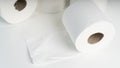 A pile of toilet paper rolls on a white table Royalty Free Stock Photo