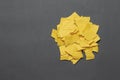 Pile of torn yellow paper scraps on a gray background. Space for text. Royalty Free Stock Photo