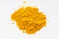 Pile of Turmeric Curcuma powder close up on gray